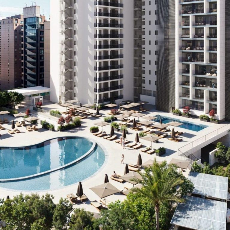 Hotel resort swimming pool and sun loungers